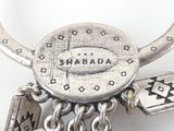 a close up of a silver necklace with charms on it