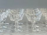 six wine glasses lined up in a row on a table