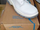 two pairs of shoes that are on top of a box