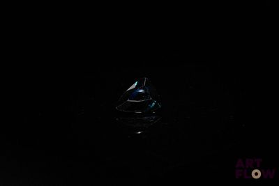 a small boat floating in the water at night