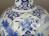 a blue and white vase with a bird on it