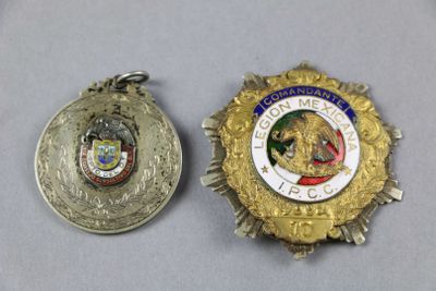 two medals are shown next to each other on a table