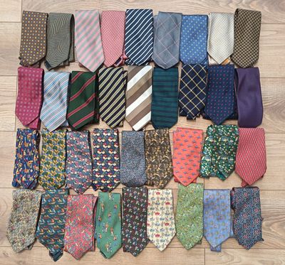 many different types of ties laid out on the floor