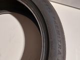 a close up of a tire on a white surface