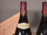 two bottles of wine sitting next to each other on a table