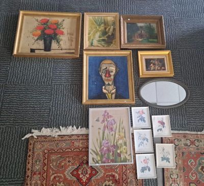 a lot of framed pictures on the floor next to a mirror