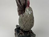 a bird that is sitting on top of a piece of wood