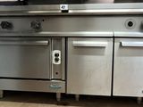 une grande cuisinière et un grand four en acier inoxydable dans une cuisine