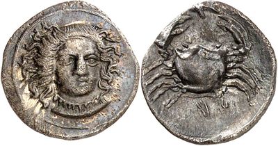 a silver coin with a head of a man on it