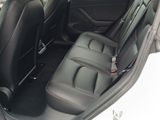 the back seats of a car are empty in a parking lot