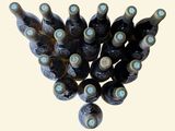 many bottles of wine that are stacked on top of each other