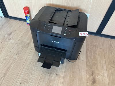a printer that is sitting on the floor next to a can of soda