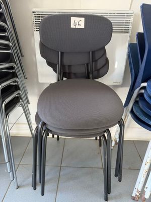 a stack of chairs and a chair with a price tag on it