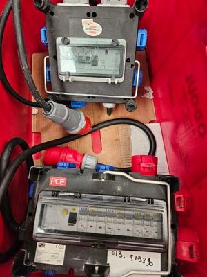 two electronic devices that are sitting on a red surface