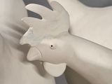 two white ceramic birds that are sitting on a table