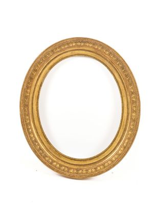 an oval gold frame with a decorative pattern