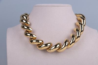an image of a gold necklace on a mannequin mannequin