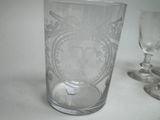 a glass with a design on it next to a glass with a design on it
