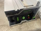 a close up of a table saw on a floor in a room