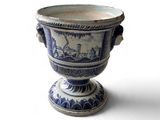 un vase bleu et blanc posé sur une surface blanche