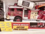 a toy fire engine in the box on the shelf