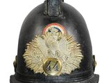 an old fireman ' s helmet with a red ball on top of it