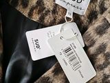 a close up of a label on a fur coat that says sud