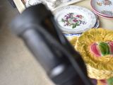 many plates and cups on a table with a remote control