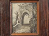 an old picture of a wooden frame with a picture of a building in it