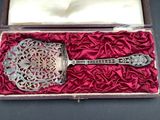 a silver spoon in a red box on a black table
