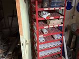many rolls of toilet paper on a rack in a garage