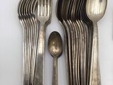 a lot of silver spoons and spoons on the table