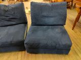 pair of blue velvet lounge chairs in a room with wood flooring