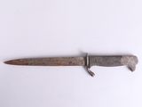 a knife that is laying on a white surface