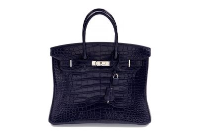 an image of a black crocodile skin handbag on a white background