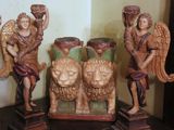 four wooden statues of angels on a shelf next to each other
