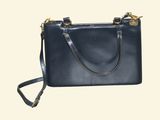 black leather handbag with gold hardware and strap