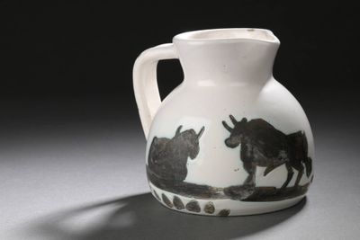 a black and white vase with a picture of two horses on it