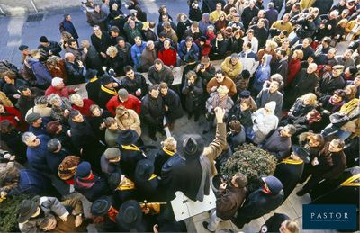 a large crowd of people standing outside of a building