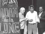 black and white photograph of a group of men standing in front of a sign