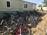 many bikes that are lined up in front of a house