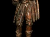 bronze statue of a man holding a bird on a black background