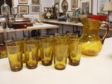a lot of glasses and a pitcher on the table