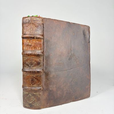 an old book with a few books sitting on top of it