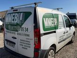 a van that is parked in a lot with other vehicles