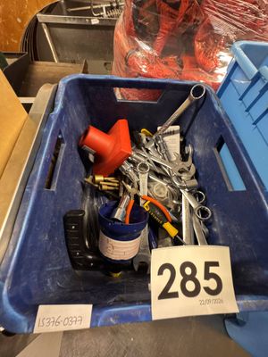 a blue bin filled with assorted tools in a store
