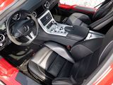 the interior of a red sports car with black leather seats