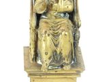 a gold statue of a man sitting on a throne