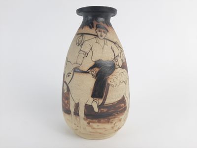 a vase with a painting on it on a white surface