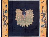a blue and orange rug with a peacock on it